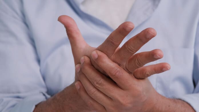 An Asian man has tingling and numbness in his hand which causes