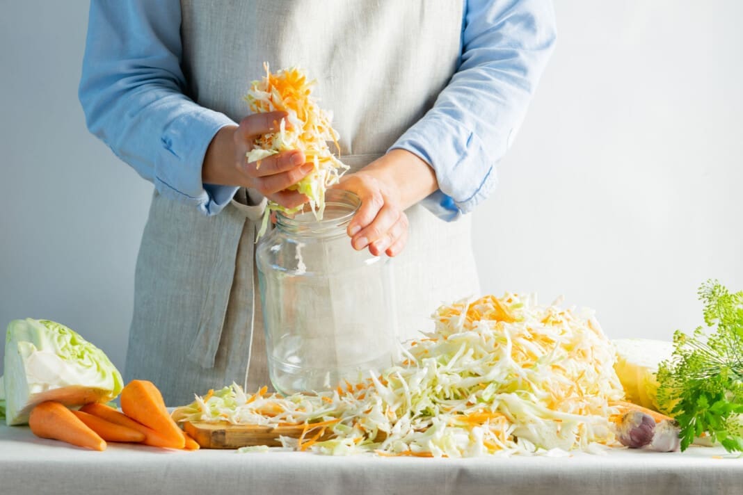 The preparation process fermentation preservation Sauerkraut on a light background. Natural rustic style. Canned food
