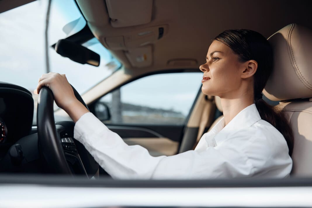 Car, woman, eyes closed, hand on steering wheel a woman sits in the driver's seat of a car, her eyes closed peacefully, while her hand rests on the steering wheel, suggesting relaxation or a moment of