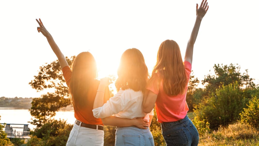 International Womens Day. Women, Female, Feminism, Friends, Girl power, diversity, femininity Concept. Group of three happy young women having fun outdoor