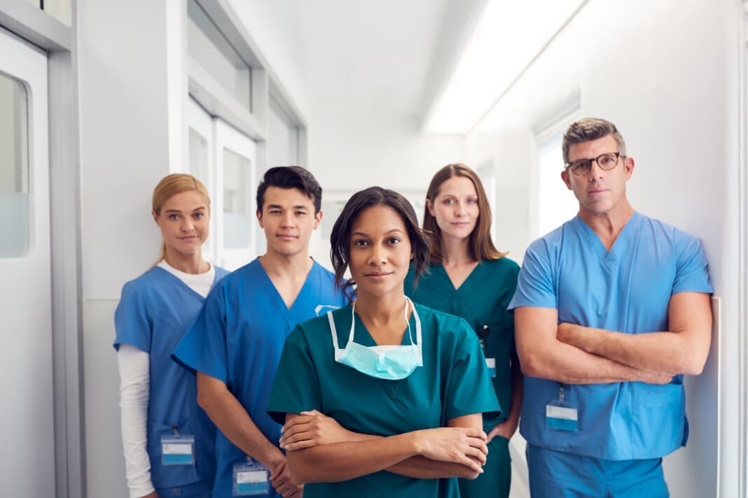 Portrait Of Multi-Cultural Medical Team Standing In Hospital Corridor