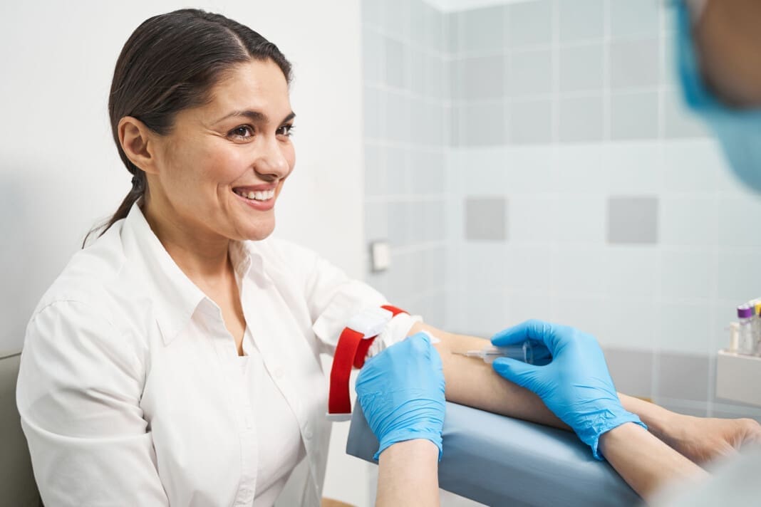 Cheerful brunette female person looking at her doctor Joint Pain Care Using PRP and Peptides for Recovery