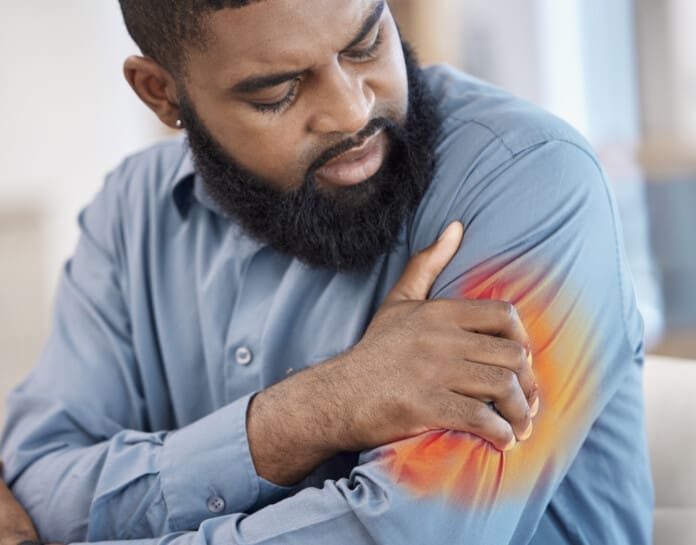 adult-male-experiencing-pain-in-arm-at-home-2026-03-25-02-24-18-utc