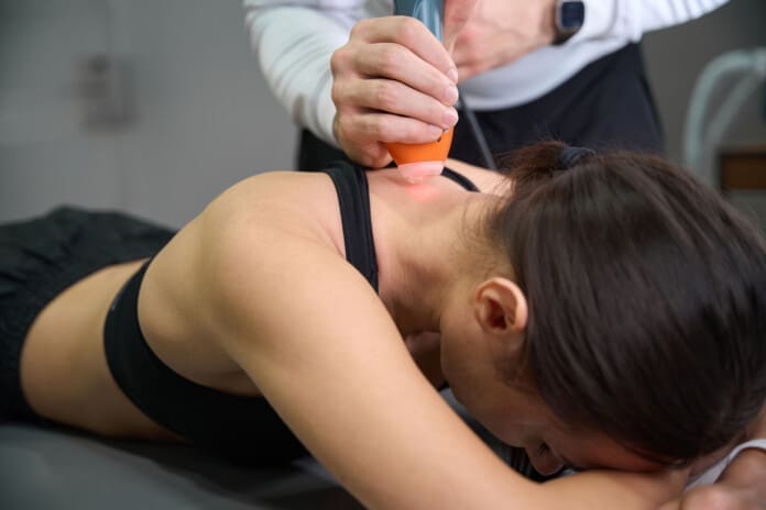 Client on treatment with laser machine in hospital Chiropractic and Laser Therapy for Pain Relief Solutions