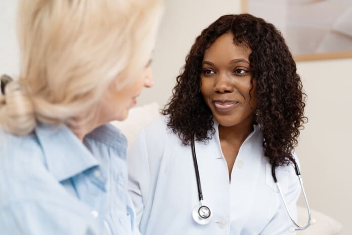 Healthcare Professional Comforting Elderly Patient During Medical Consultation