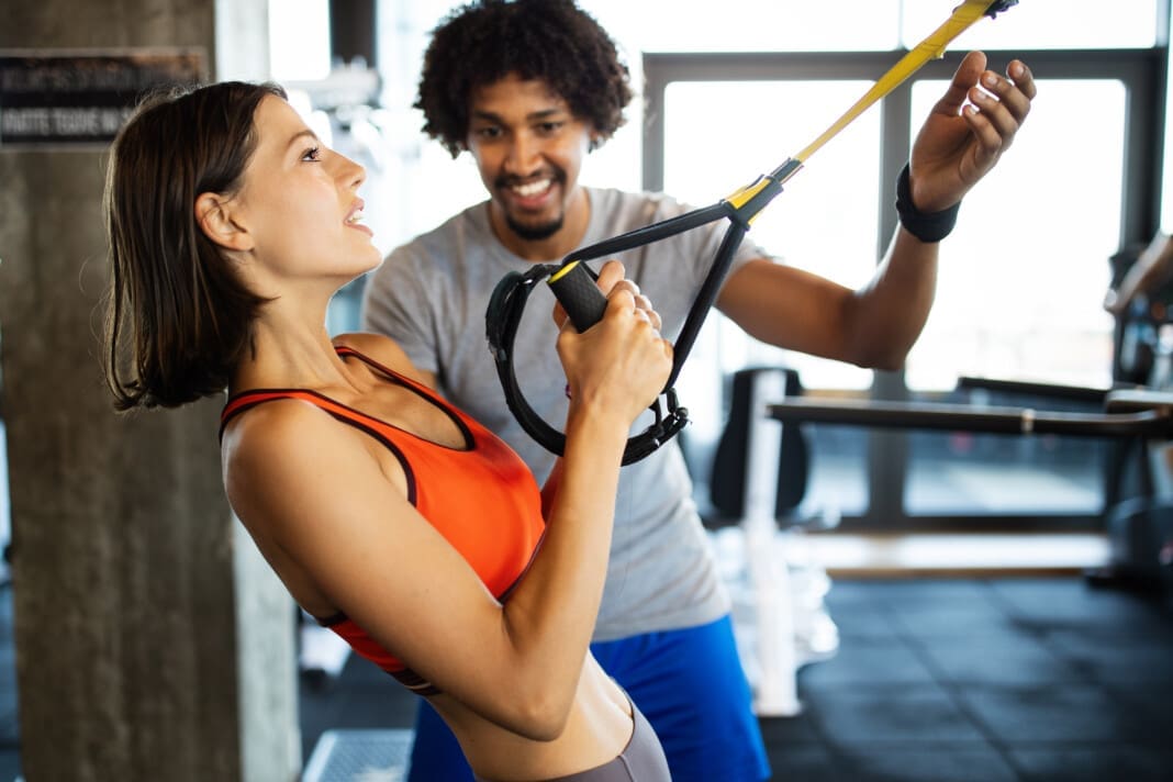 Group of young people doing exercises in gym