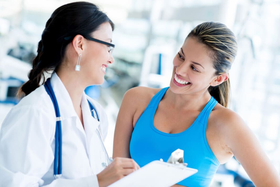 Female Doctor At The Gym With A Patient Integrative and Regenerative Sports Chiropractic Healing